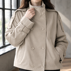 Close view of the khaki jacket showing its double breasted buttons and belted cuffs