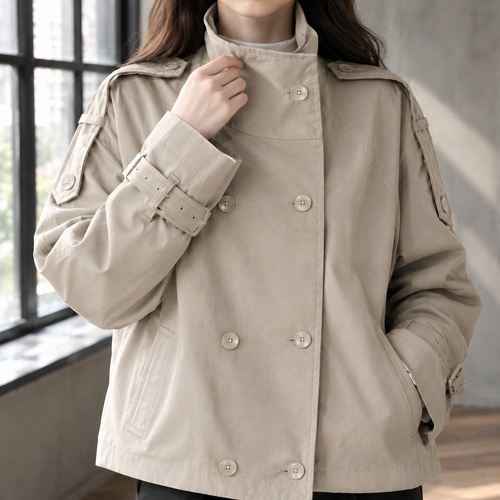 Close view of the khaki jacket showing its double breasted buttons and belted cuffs