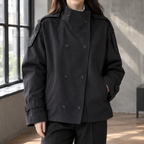 Woman wearing the double breasted stand collar jacket in black with statement cuffs