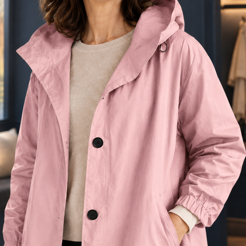 Close view of the light pink hooded overcoat showing its smooth shell and angled pockets
