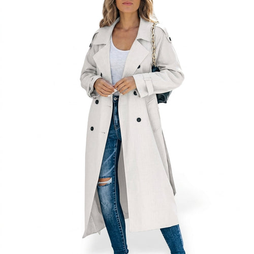 Woman wearing a white longline trench coat with wide lapels and double breasted buttons