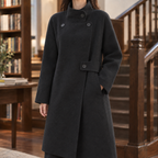 Woman wearing the longline wool coat in black with a relaxed asymmetric silhouette