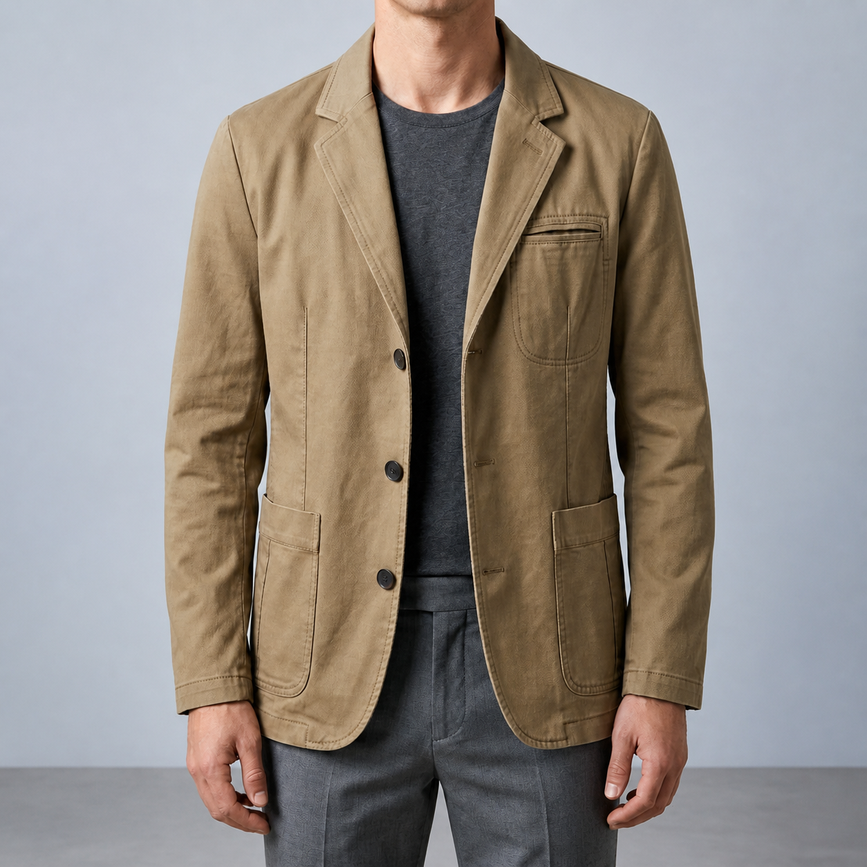 Khaki mens denim blazer with button front and patch pockets, worn over a charcoal shirt.