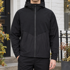 Hooded Jacket in Black showing the drawcord hood, chevron yoke, and relaxed fit.