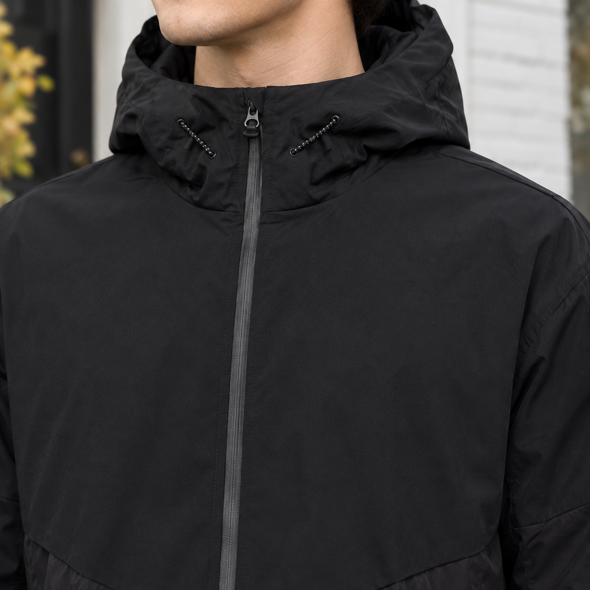 Hooded Jacket detail view 2 showing the drawcord hood, chevron yoke, and relaxed fit.
