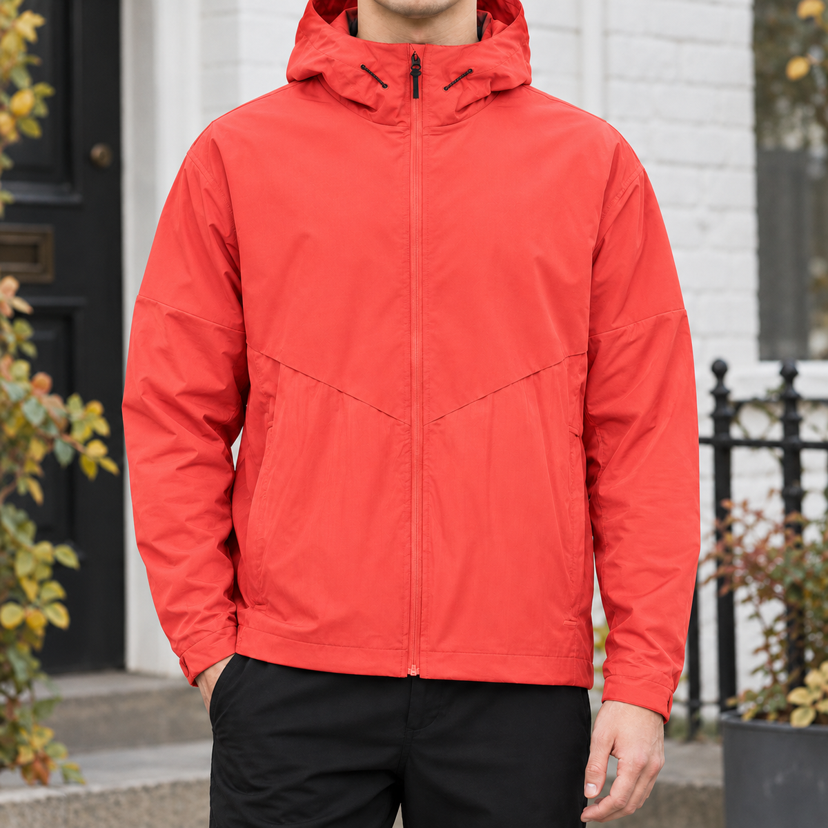 Hooded Jacket in Orange Red showing the drawcord hood, chevron yoke, and relaxed fit.