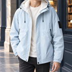 Hooded Jacket in Light Blue showing the fleece-lined hood, zipped pockets, and elasticated cuffs.