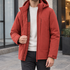 Hooded Jacket in Ceramic Red showing the quilted lining and adjustable cuff tabs.