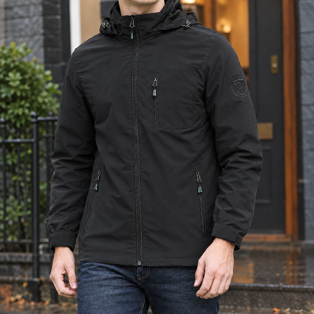 Hooded Utility Jacket in Black showing the adjustable hood and three zipped pockets.