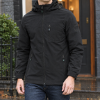 Hooded Utility Jacket in Black showing the adjustable hood and three zipped pockets.