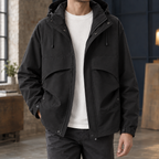 Hooded Utility Jacket in Black showing the drawcord hood and four front pockets.