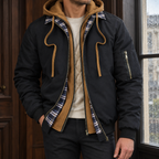 Layered Jacket in Black showing the layered hood panel, plaid collar trim, and quilted lining.