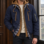 Layered Jacket in Navy Blue showing the layered hood panel, plaid collar trim, and quilted lining.