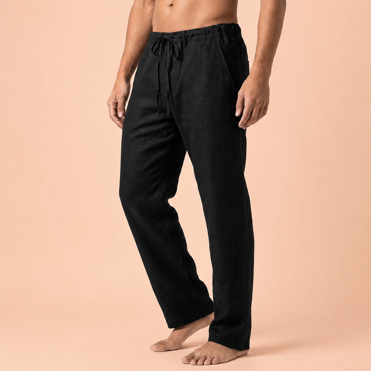 Black drawstring trousers with one bent leg