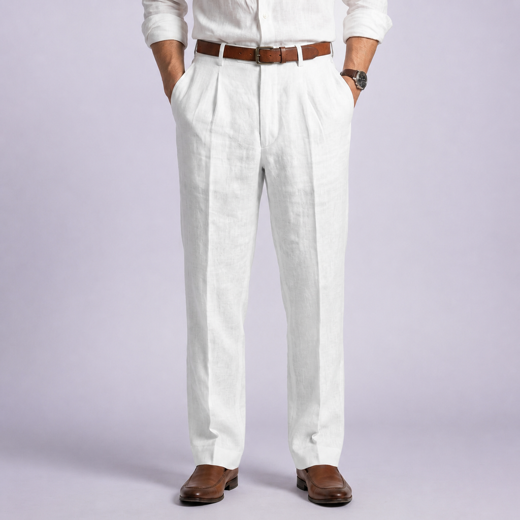 White mens linen trousers with front pleats and belt loops, worn with a brown belt and loafers.