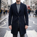 Overcoat in Black showing the notched tailored collar and longline silhouette