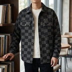 Denim Jacket in Black showing the tonal patchwork texture and flap chest pockets