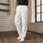 White full length pleated pants worn with a black T-shirt and white shoes.