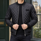 Quilted Bomber Jacket in Black showing the diamond quilting and ribbed bomber trims.