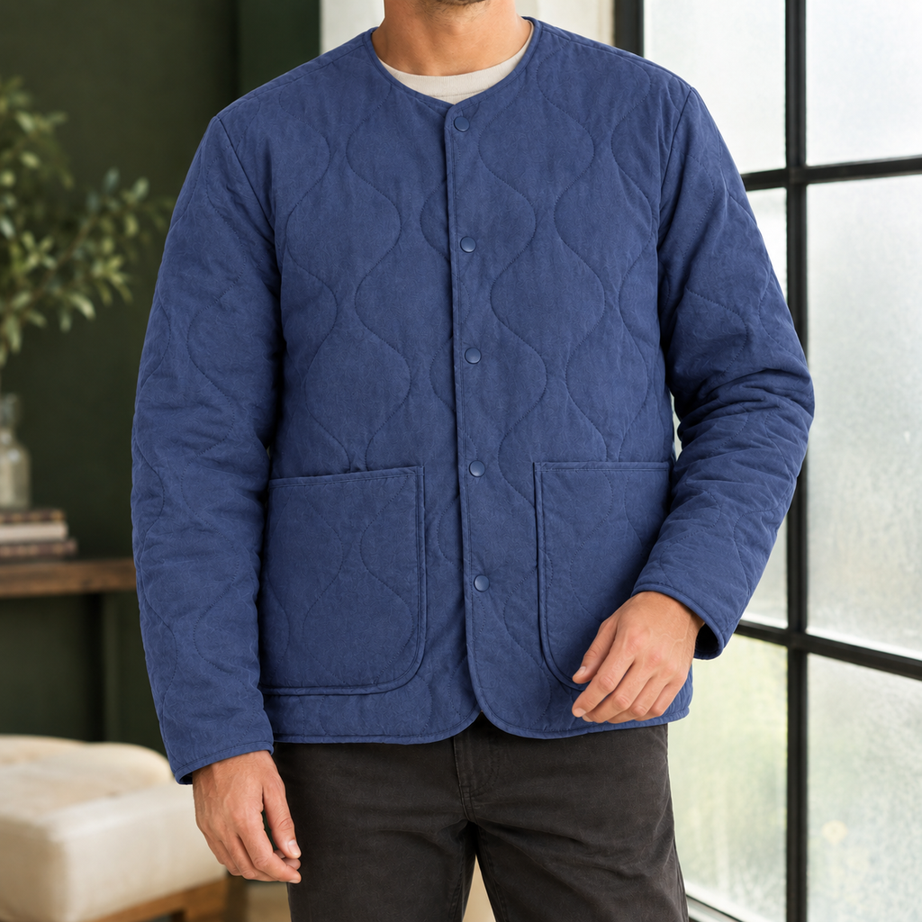 Quilted Jacket in Royal Blue showing the soft quilting, collarless neckline, and patch pockets.