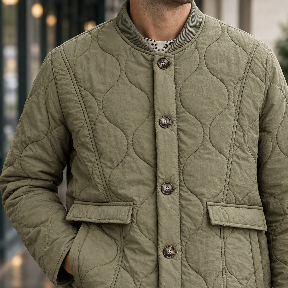 Quilted Jacket detail view 2 showing the wavy quilting, ribbed round collar, and side-entry pockets.