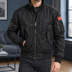 Tactical Jacket in Black showing the ribbed trims and multiple zipped pockets.