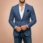 Blue tailored blazer worn over white shirt and jeans, hands fastening jacket
