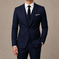 Navy mens tailored suit with matching vest and pants, worn with a white shirt and black tie.