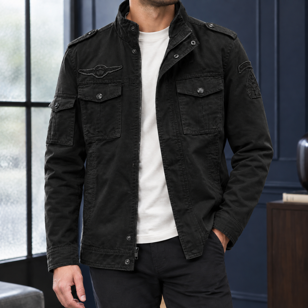 Utility Jacket in Black showing the snap flap pockets and layered front closure.