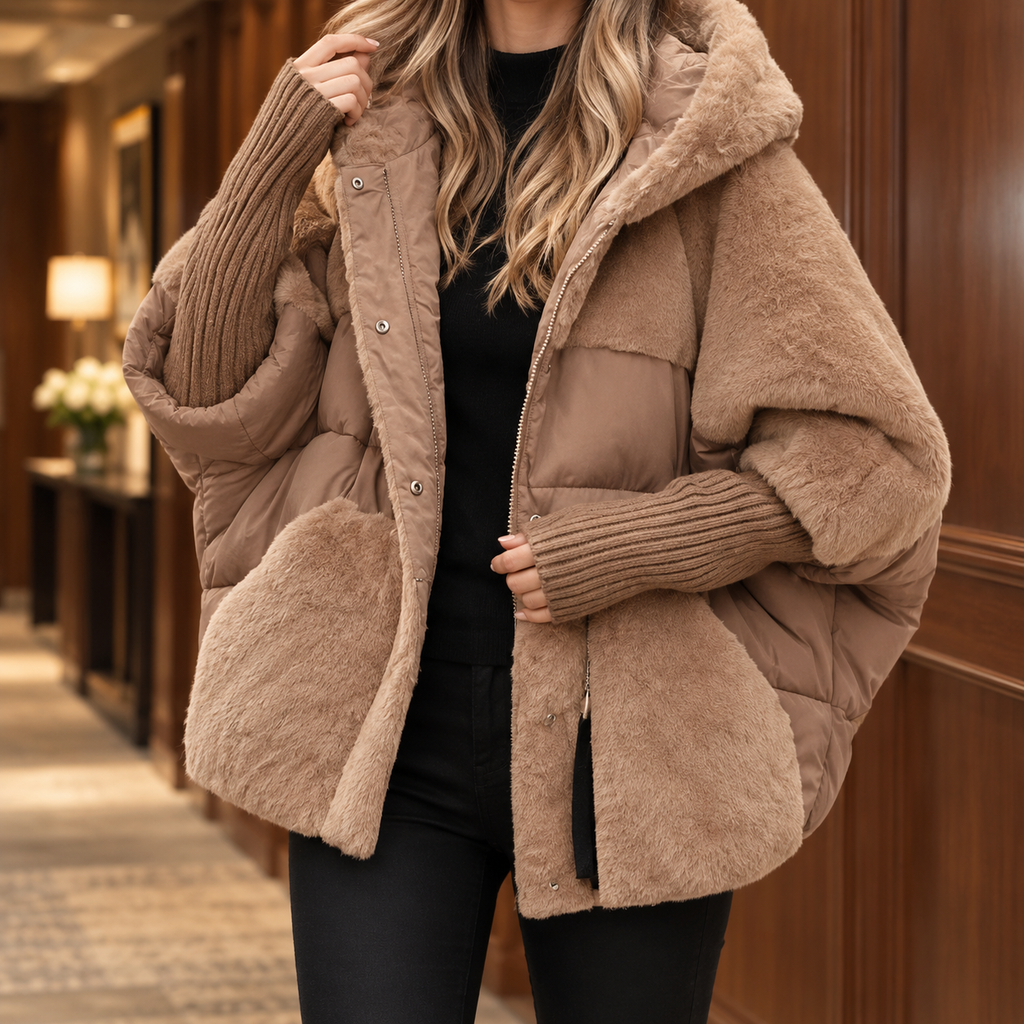 Woman wearing a light brown padded jacket with plush contrast panels and a lined hood