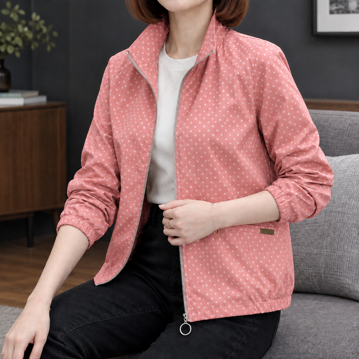 Woman wearing the polka dot zip jacket in dusty pink