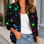 A woman wears a black printed bomber jacket with a botanical pattern, front zip and ribbed trim.