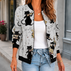 A woman wears a gray printed bomber jacket with a botanical pattern, front zip and ribbed trim.
