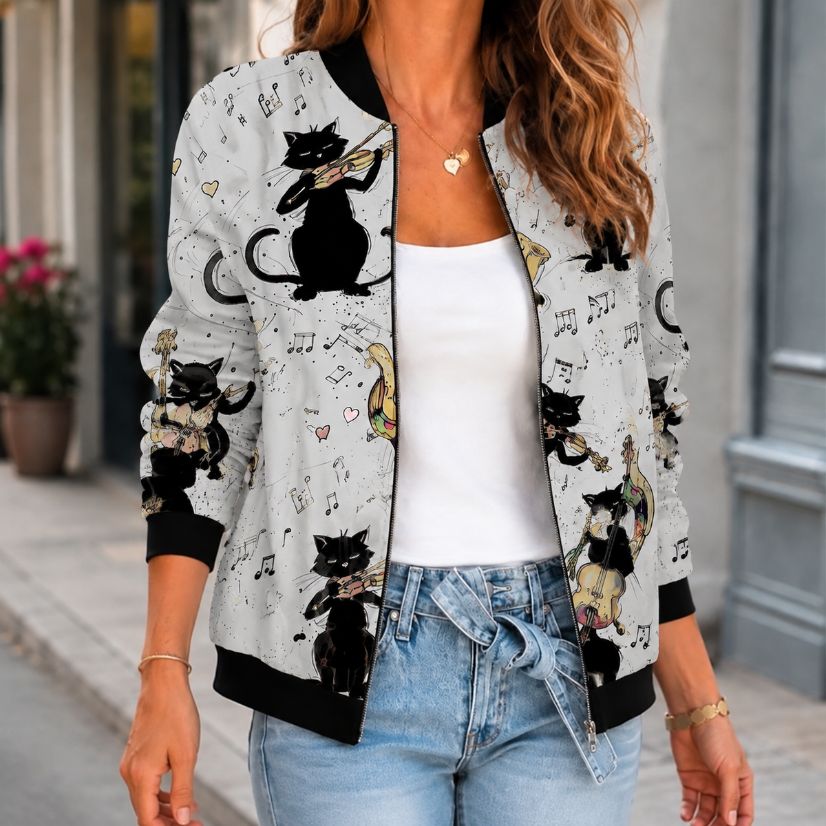 A woman wears a gray printed bomber jacket with a botanical pattern, front zip and ribbed trim.