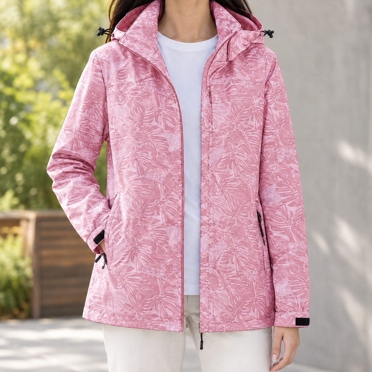 Woman wearing the tonal leaf print hooded jacket in pink