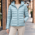 Woman wearing the slim quilted hooded jacket in pale blue