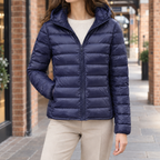 Woman wearing the slim quilted hooded jacket in navy blue