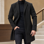 Tailored Coat in Black showing the notched lapels and shaped mid-length silhouette