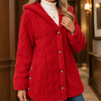 Close view of the red textured jacket showing its hood, button front and side detailing