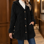 Woman wearing the plush textured hooded jacket in black