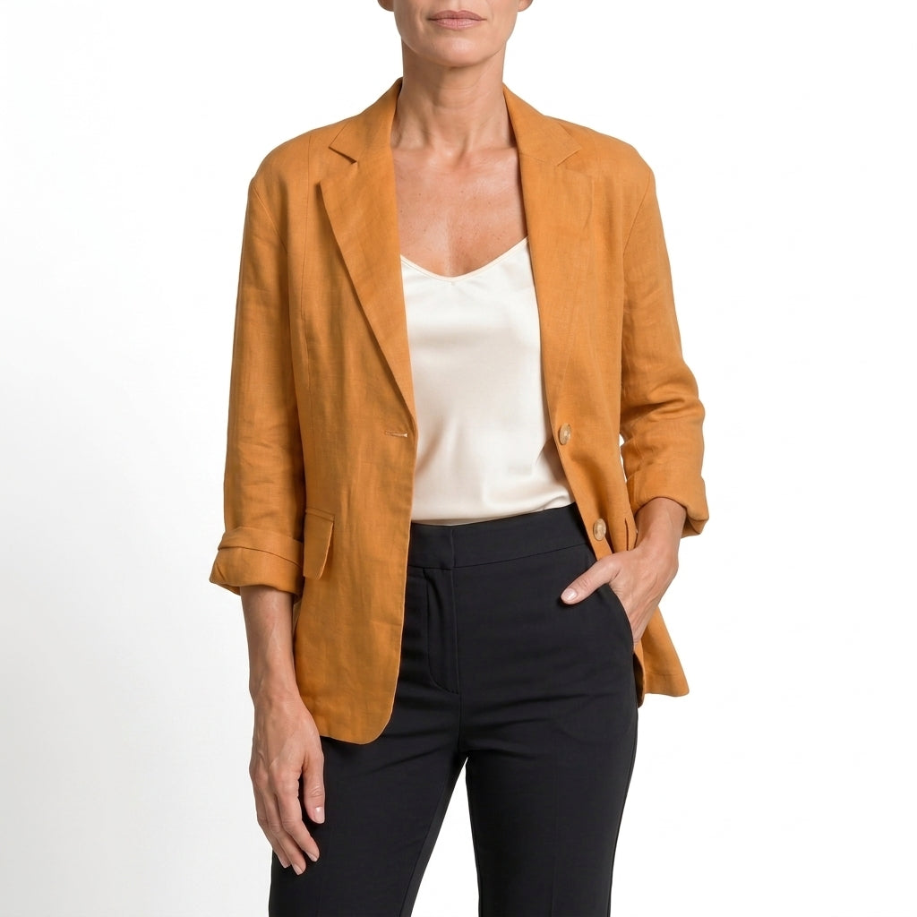 Orange cotton blend blazer with relaxed sleeves and front pockets on a model.