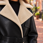 Close-up of womens faux leather flight jacket showing the collar, fastening and material texture.