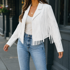 White cropped fringe jacket with an open front worn with jeans.