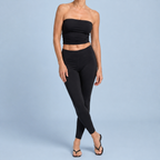 Woman wearing black toe-post kitten heel sandals