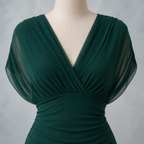 Green draped dress neckline and fitted waist detail on a dressmaker mannequin