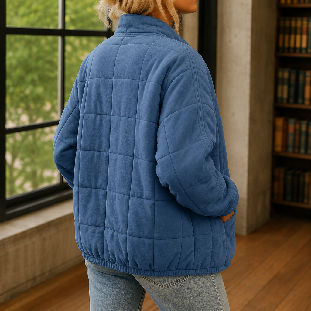 Alternate view of the blue quilted jacket and its relaxed shape.