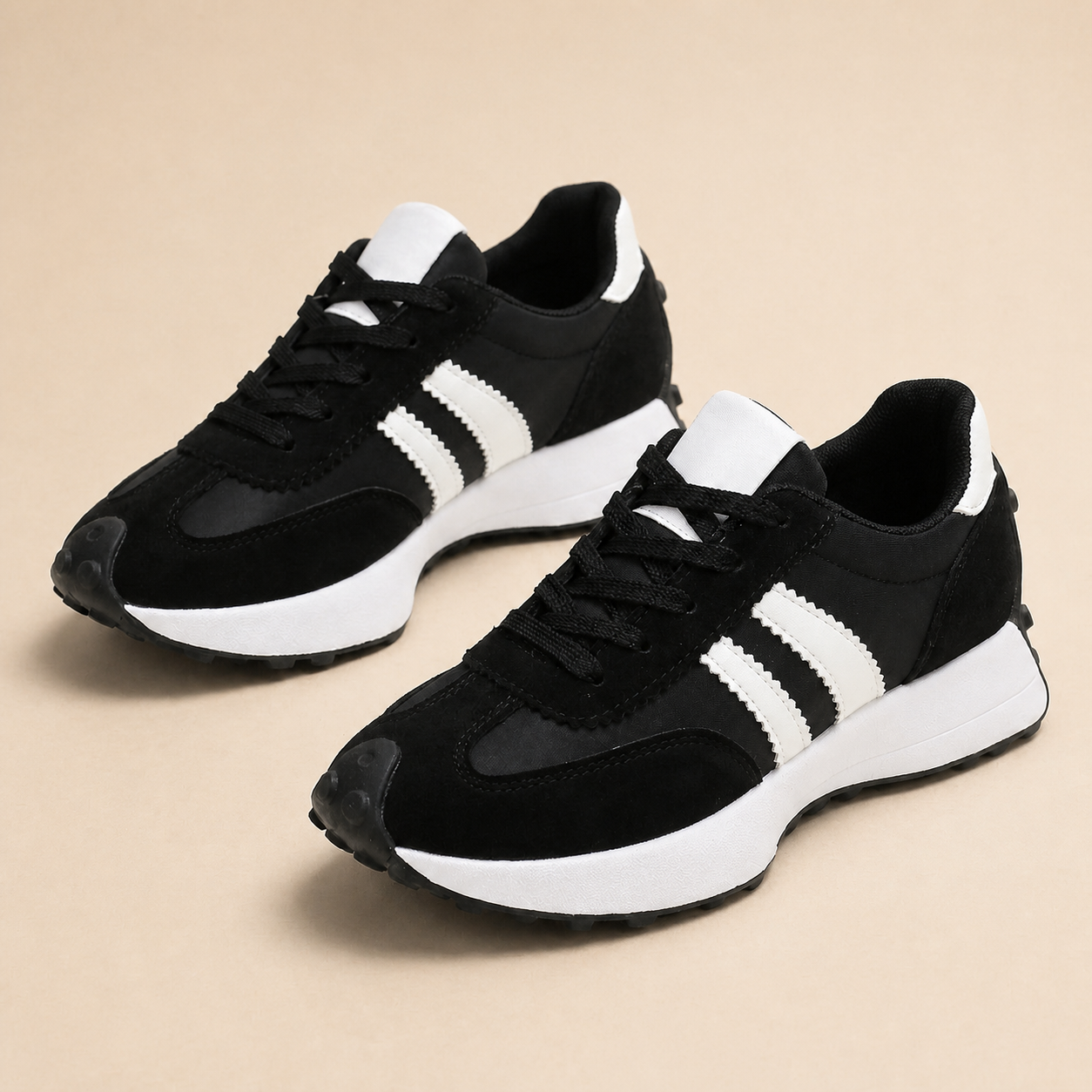 Black sneakers with white side stripes and white soles.