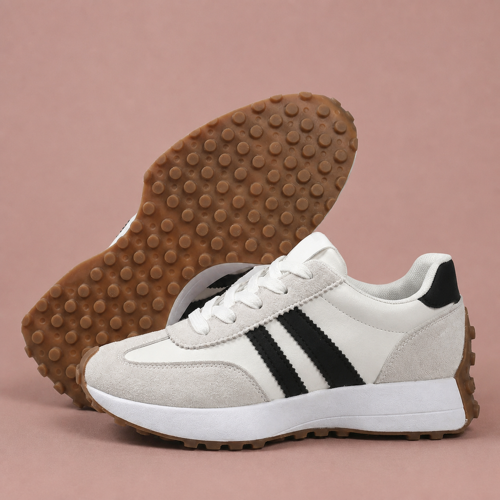 White sneakers shown from the side alongside their gum outsole tread.