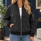 Woman wearing a black zip bomber jacket with ribbed trims and a sleeve pocket